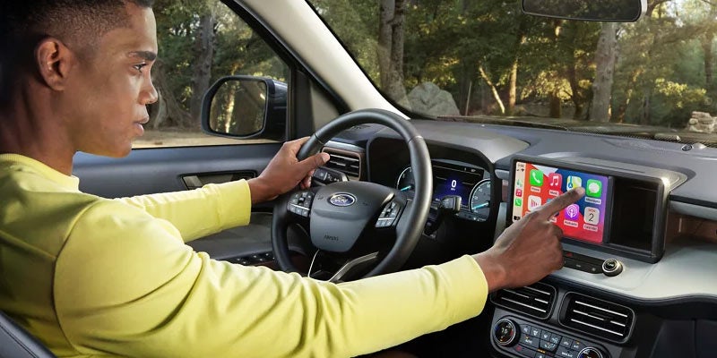 Person interacting with Ford Maverick touchscreen