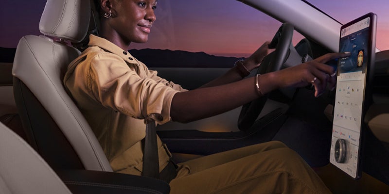 lady interacting with Ford Mustang Mach-E touchscreen