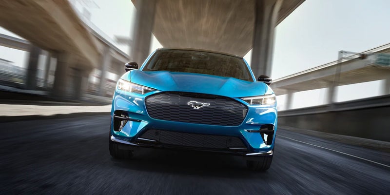 Blue Ford Mustang Mach-E driving on the road